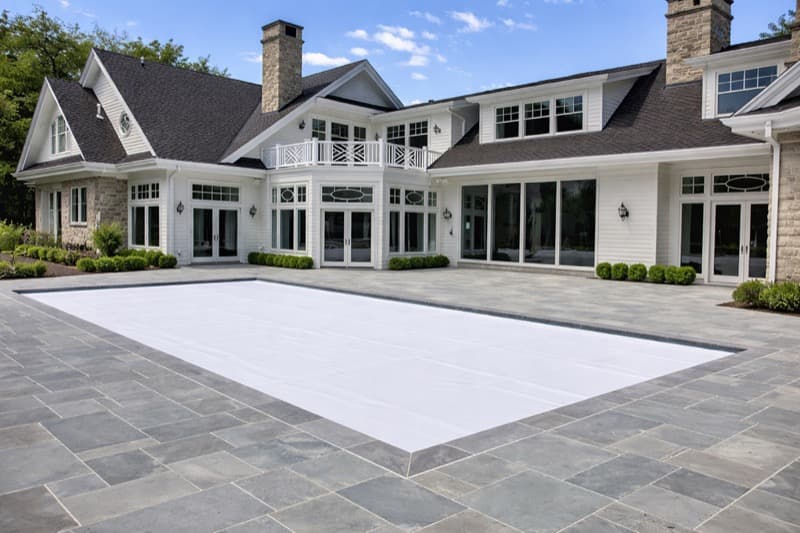 White automatic pool cover on luxury home