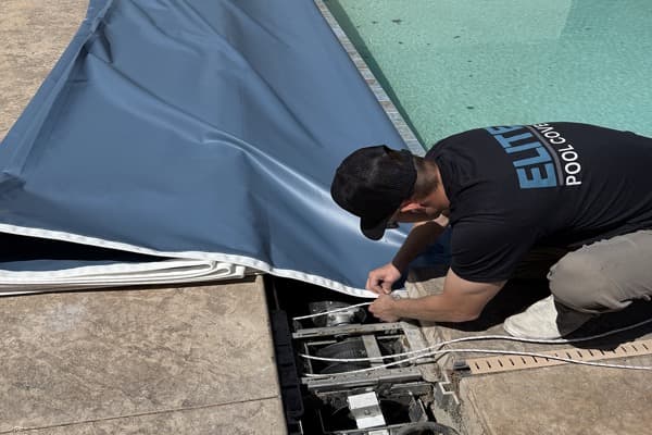 Elite Pool Covers technician servicing a pool cover